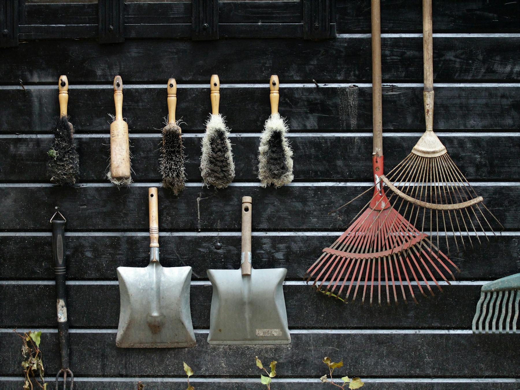 Garden tools hanging on a weathered wall, ready for daily use